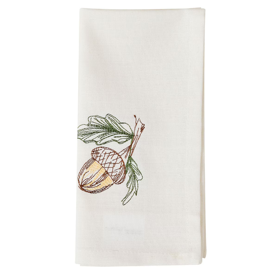 White towel with acorn and pine branch design on a white background
