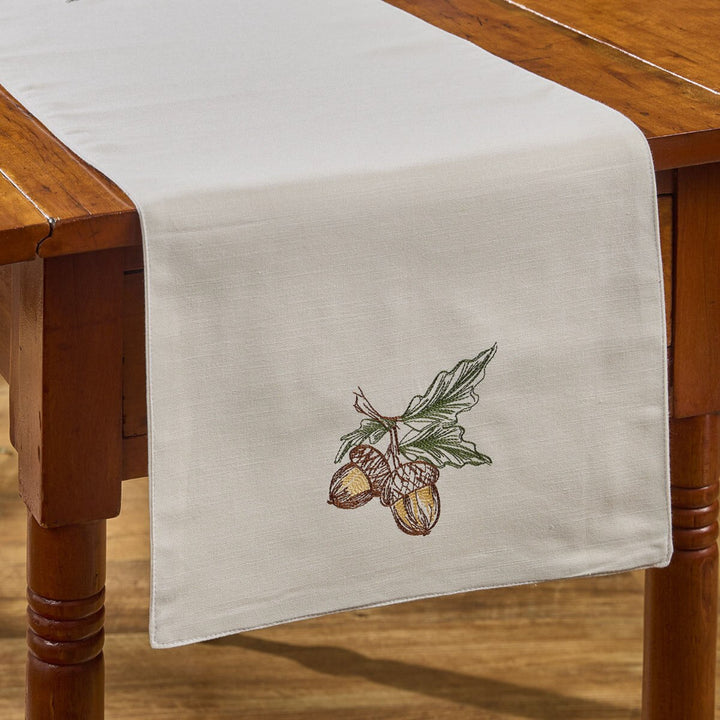 Table runner with acorn design on a wooden table