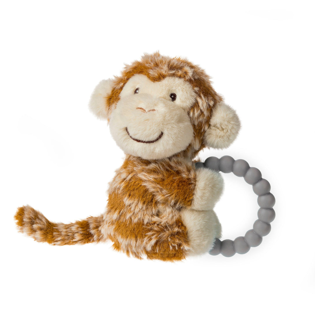Plush monkey toy with a teething ring on a white background