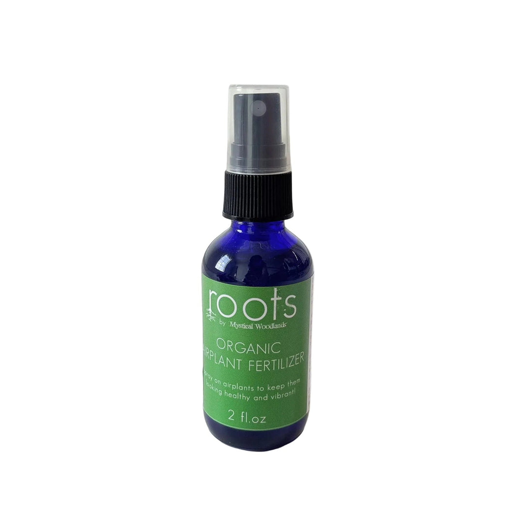 Bottle of organic plant fertilizer with 'roots' branding on a white background