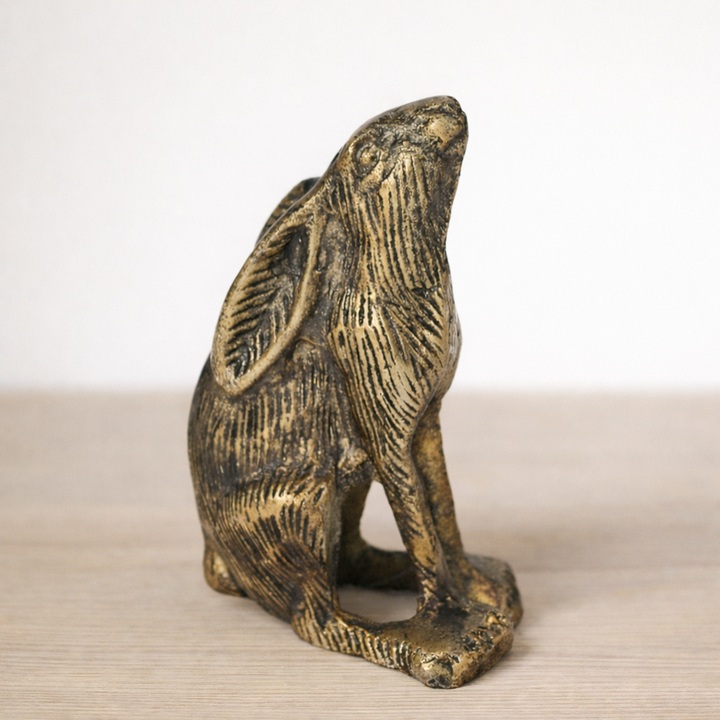 Antique Gold Sitting Rabbit Figurine on wooden surface with neutral background