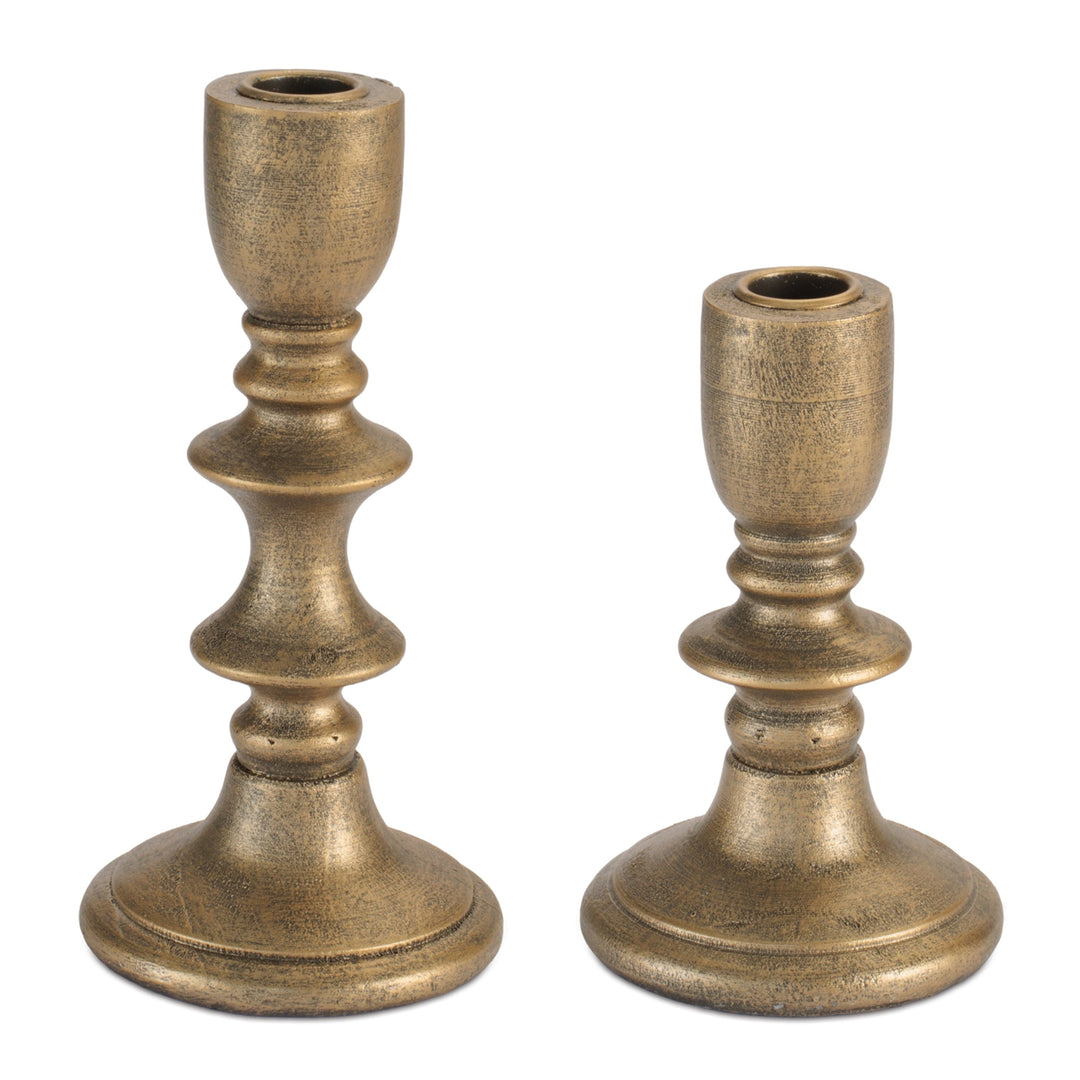 Two bronze candle holders on a white background
