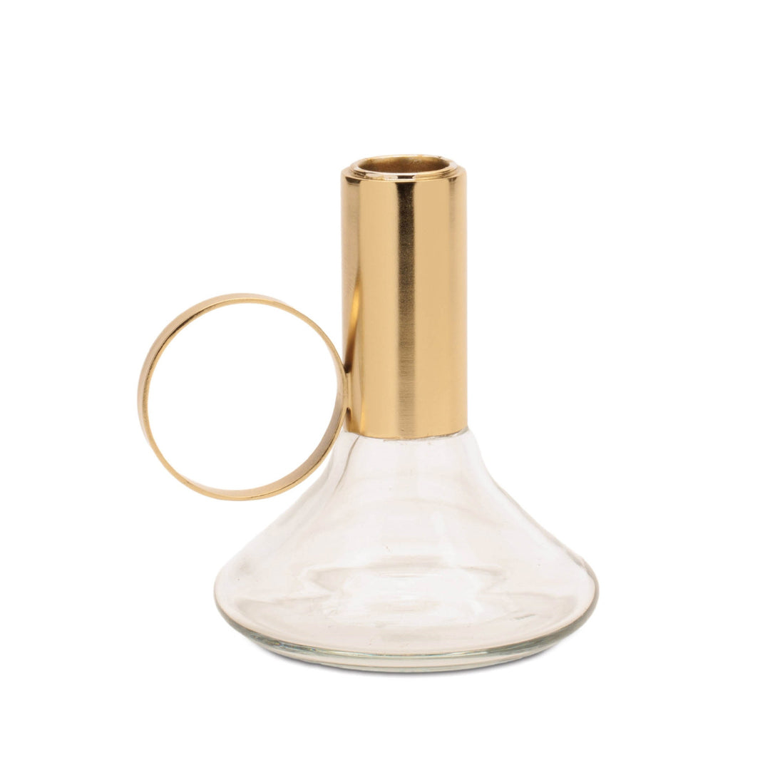 Clear glass carafe with gold metal handle on a white background