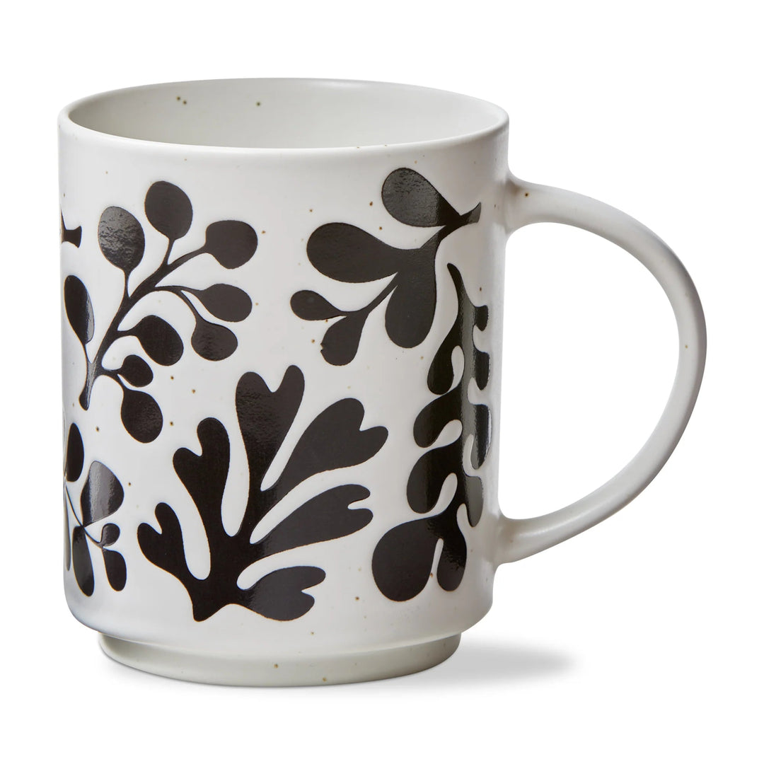 White mug with black leaf pattern on a white background
