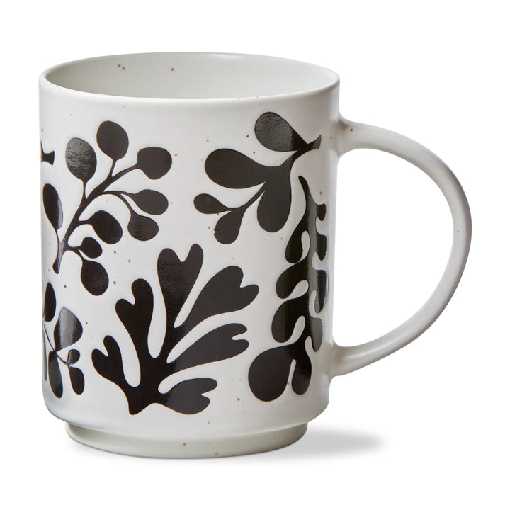 White mug with black leaf pattern on a white background