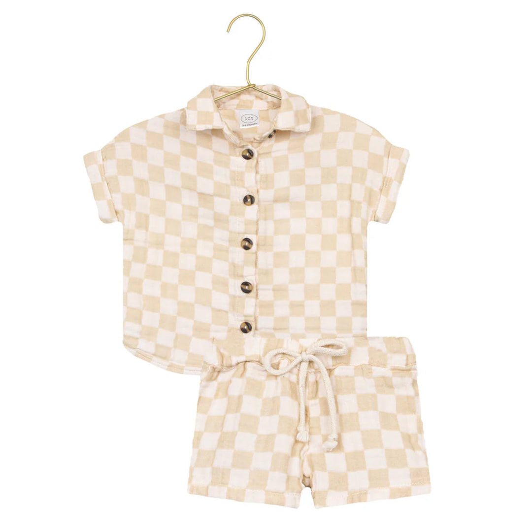A two-piece children's outfit set featuring a short-sleeve button-up shirt and matching shorts in a beige and cream checkered pattern, displayed on a gold hanger against a white background.
