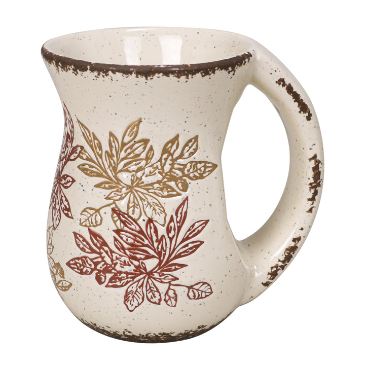 Ceramic mug with leaf pattern on a white background