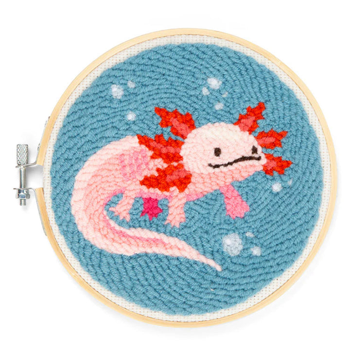 Embroidery hoop with a pink axolotl on a blue background