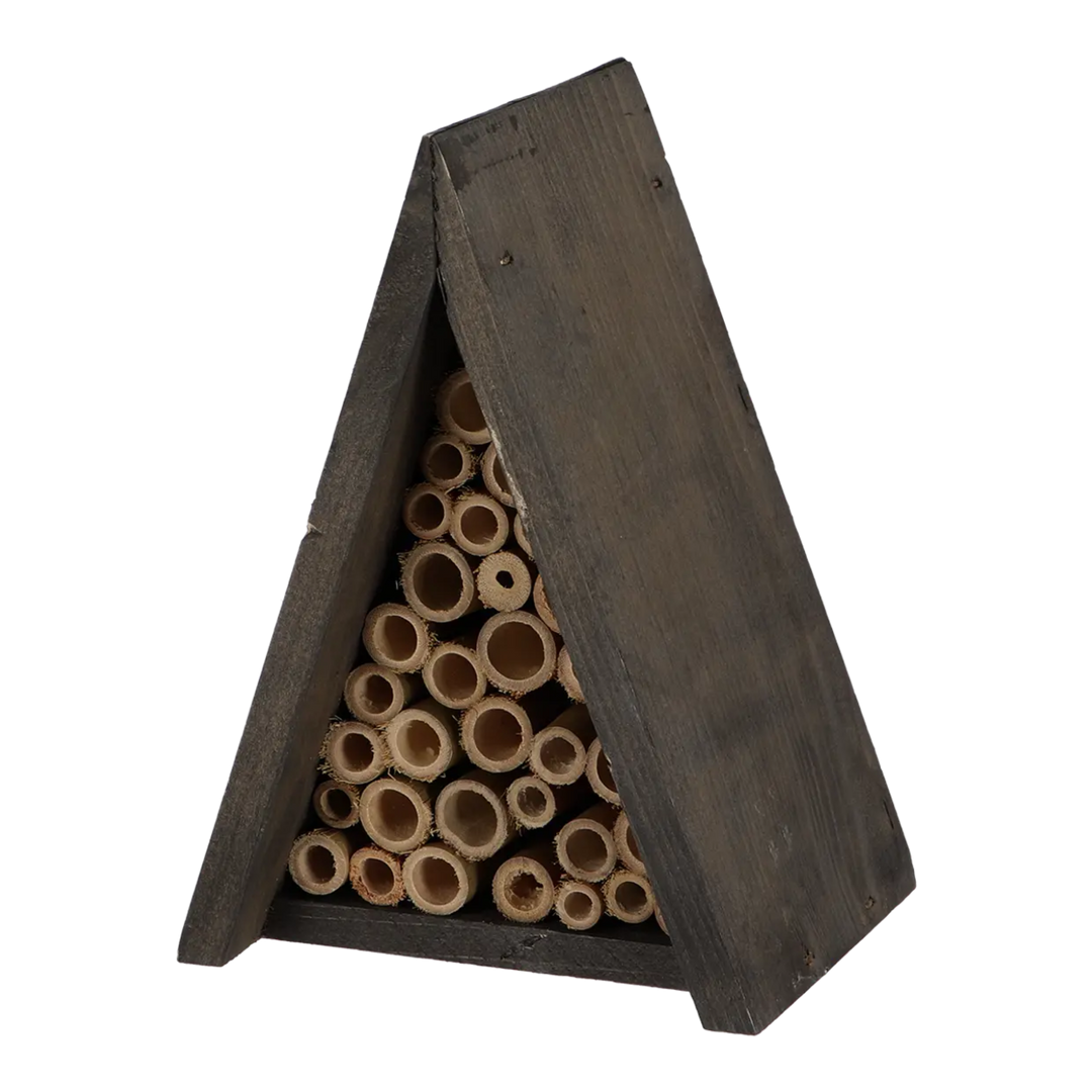 Wooden bee hotel with cylindrical compartments on a white background