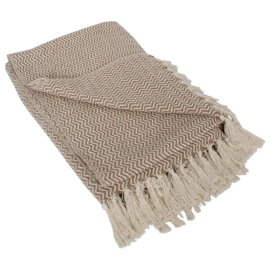 A folded woven throw blanket with a beige and brown chevron pattern and fringed edges, shown on a plain white background.