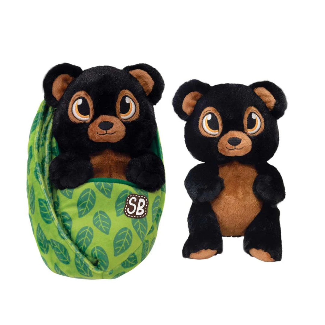 Two black and brown bear plush toys, one inside a green leaf-patterned ball, on a white background.