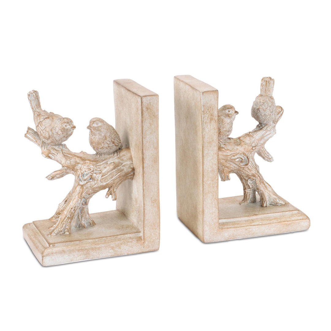 Decorative bookends with bird and branch design on a white background