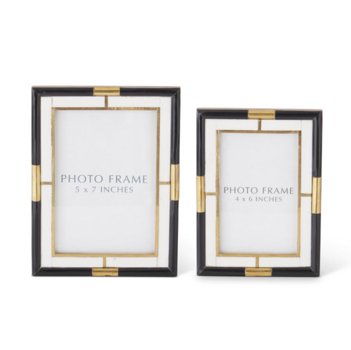 Two black photo frames with gold accents on a white background