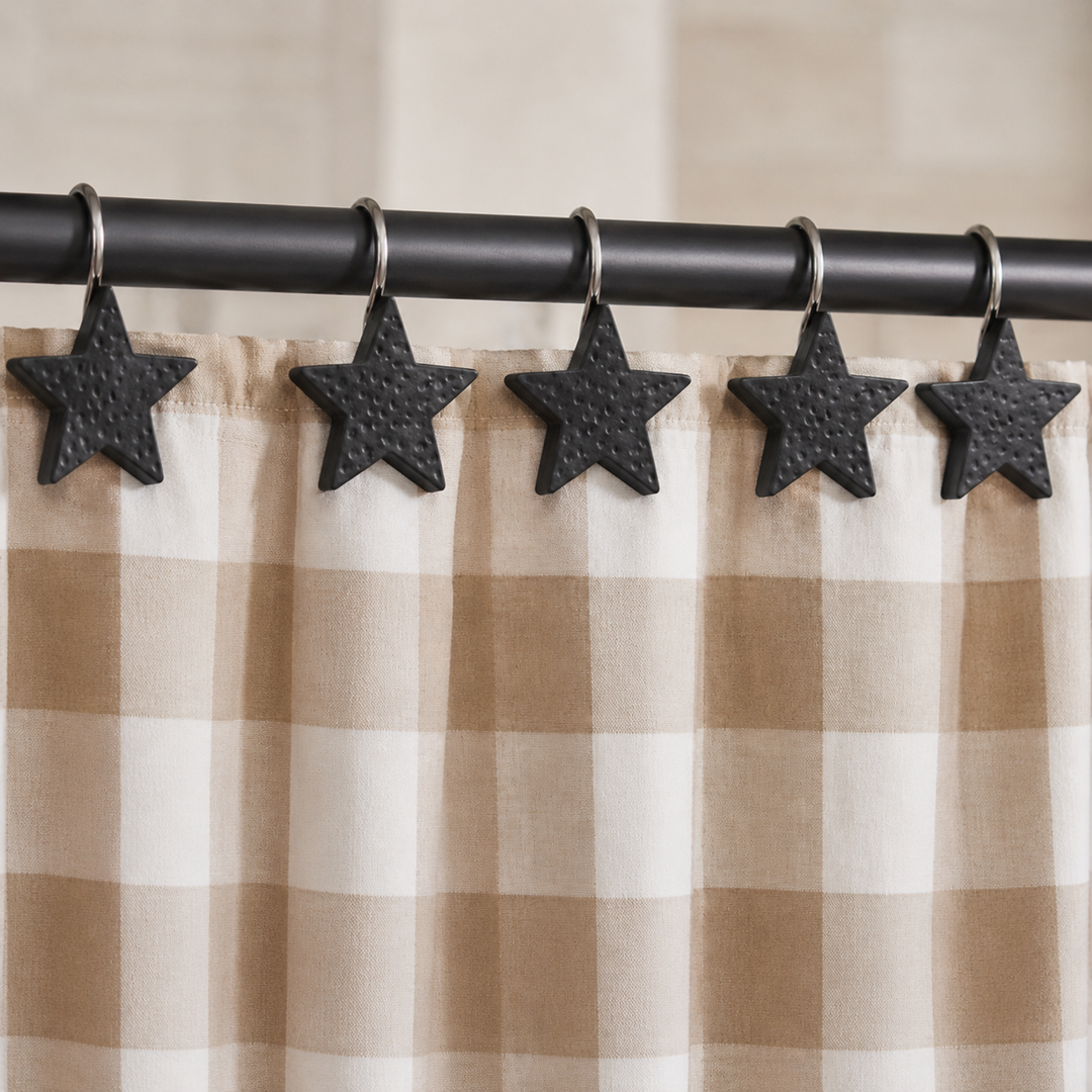 Star-shaped shower curtain hooks on a checkered curtain with a black rod.
