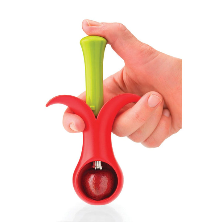 Hand holding a red and green kitchen tool on a white background