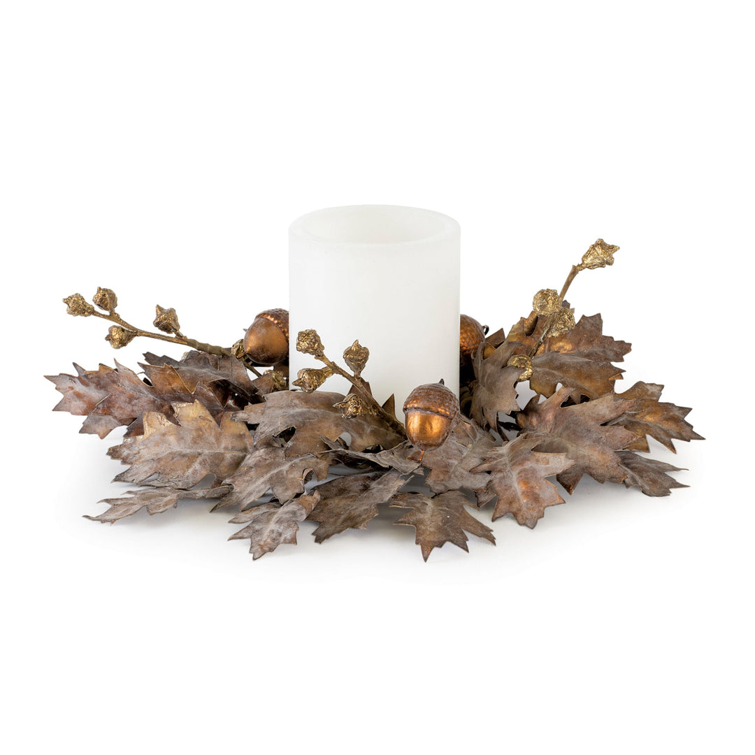 Decorative candle holder with leaves and acorns on a white background