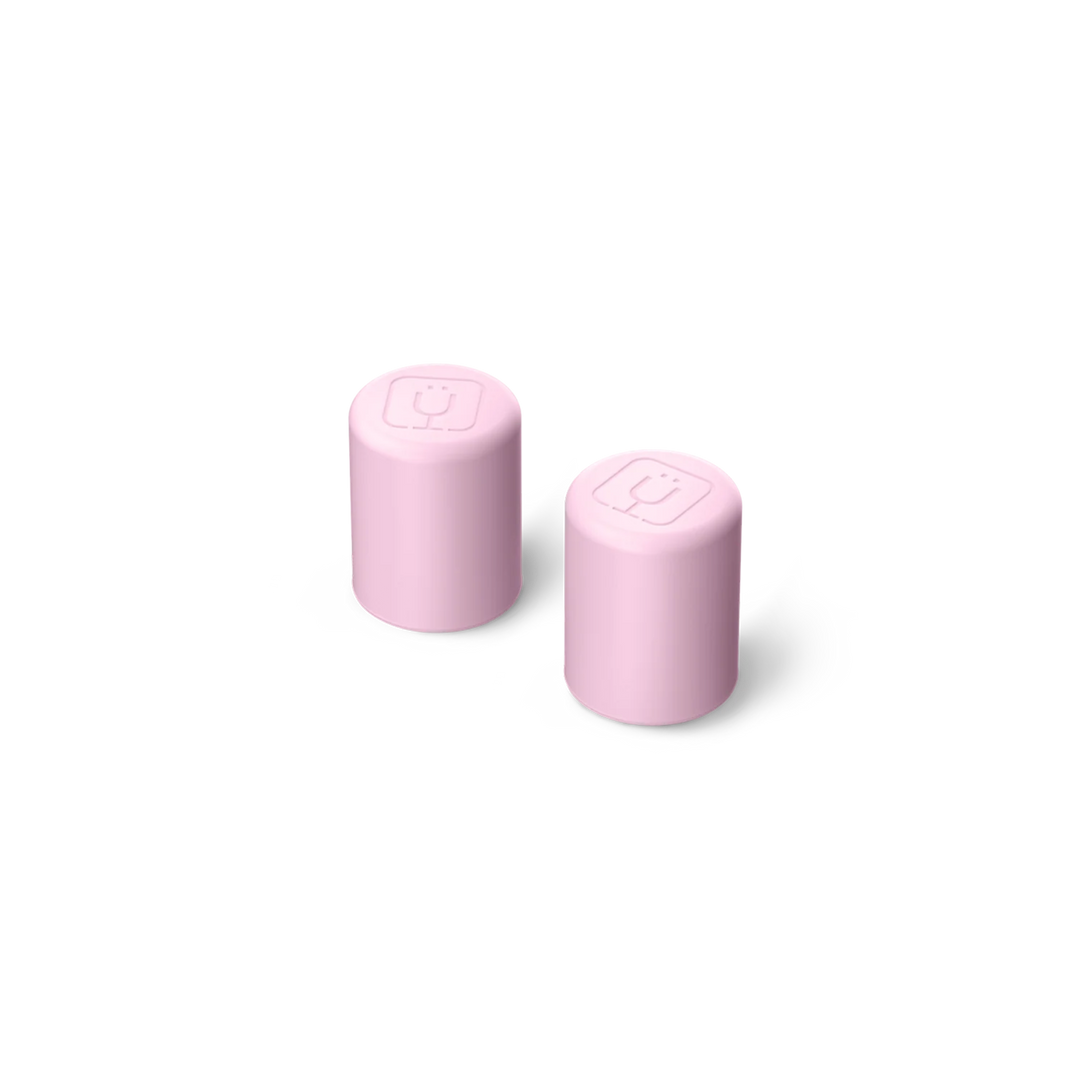 Two pink cylindrical objects with square designs on a white background