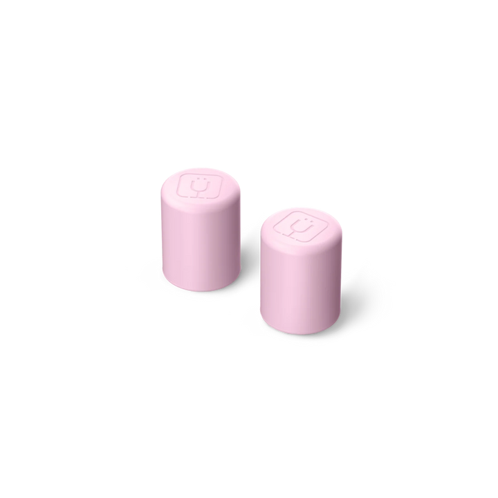 Two pink cylindrical objects with square designs on a white background