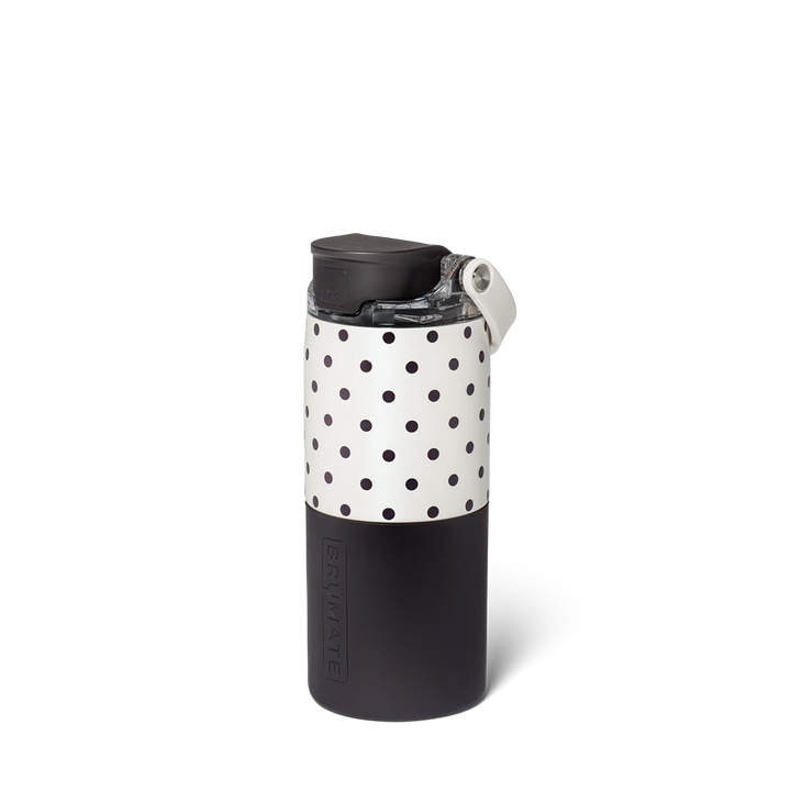 A reusable insulated tumbler with a black lower half, a white upper half covered in black polka dots, and a black lid with a small white loop, shown on a white background.