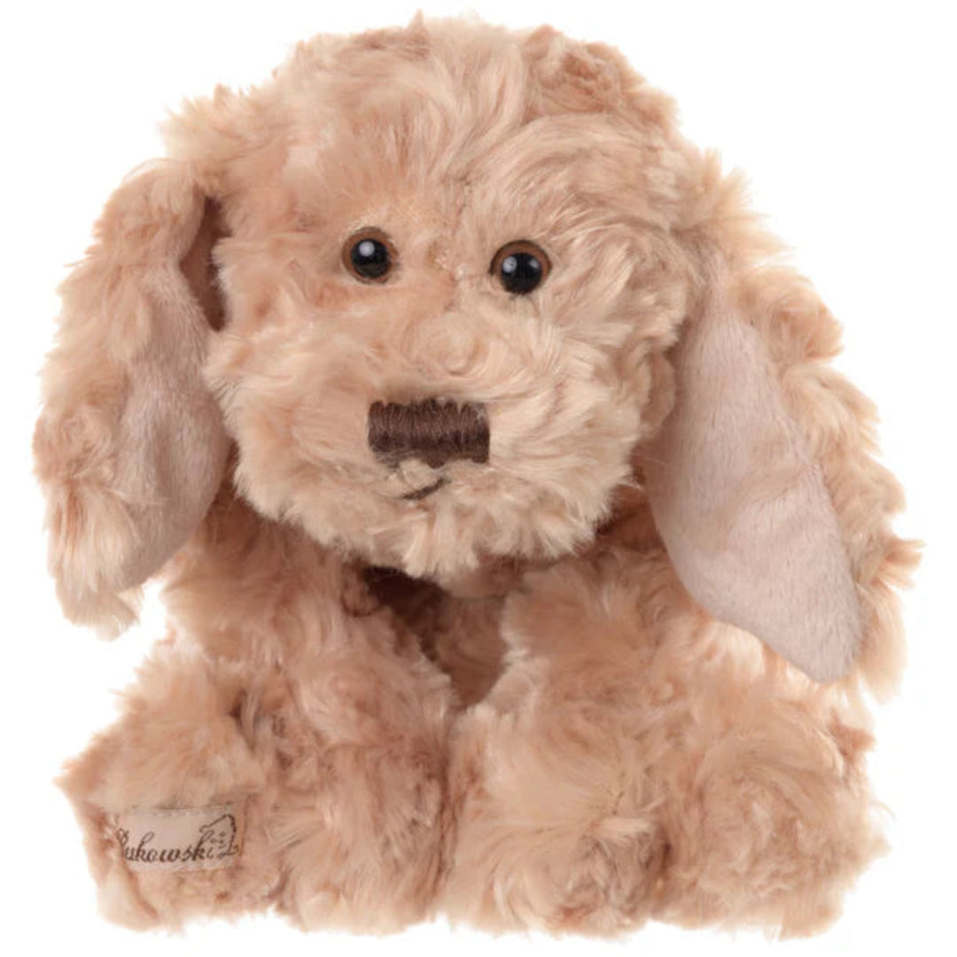 long eared dog stuffed animal sitting on white background