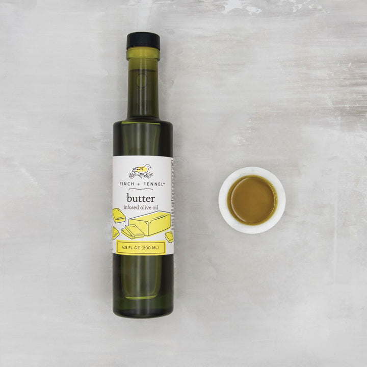 Bottle of Finch + Ferned butter infused olive oil on a light gray background