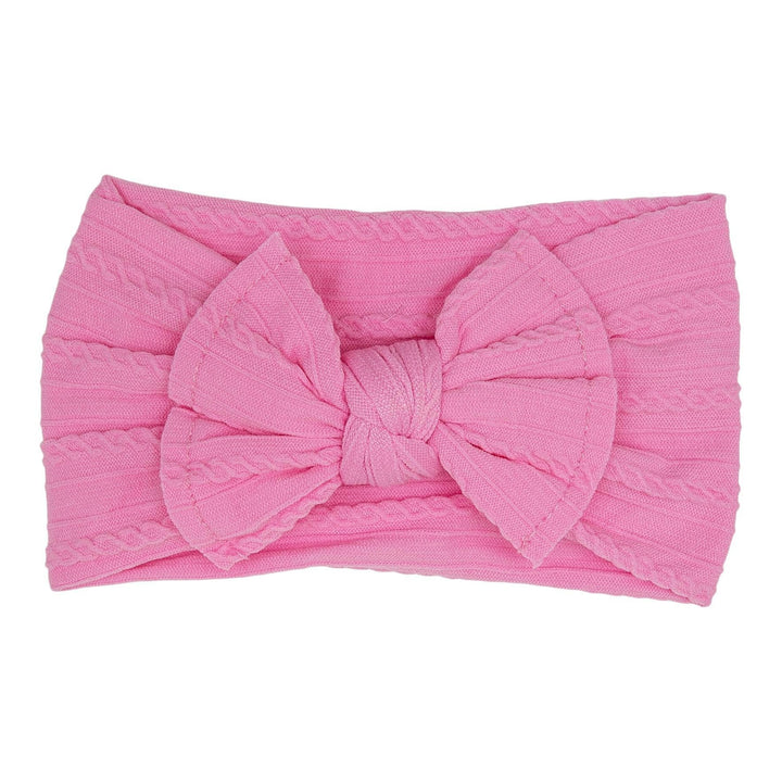 Pink headband with a large bow on a white background