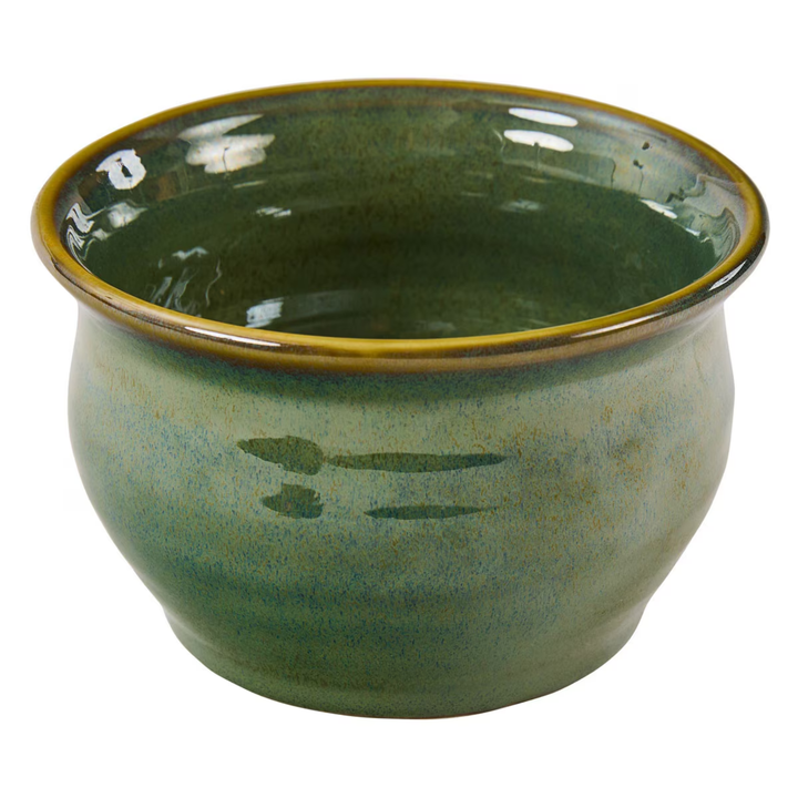Green ceramic bowl with a textured surface on a white background