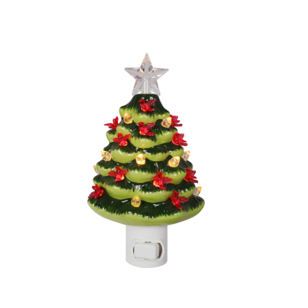 Two small Christmas tree night lights on white plastic bases, shown side by side against a white background. The left tree is dark green with red ornaments and gold lights turned on.