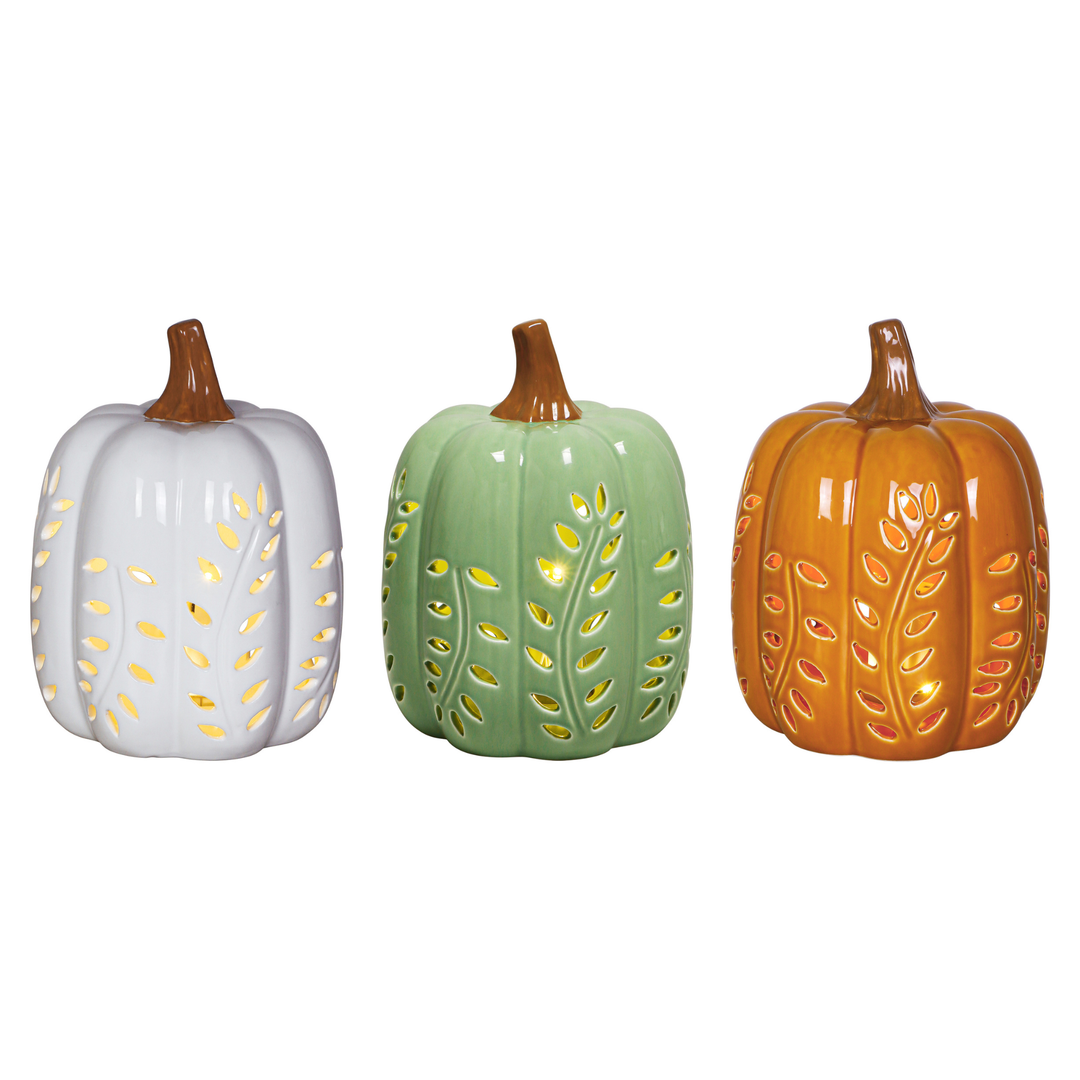 Three decorative ceramic pumpkins in white, sage green, and orange, each with a brown stem and gold leaf cutout details, displayed against a plain white background.