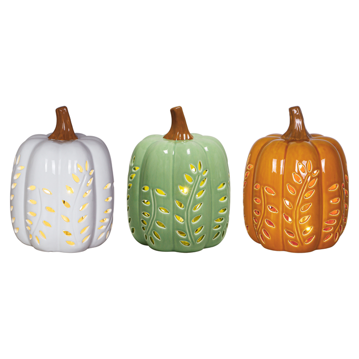 Three decorative ceramic pumpkins in white, sage green, and orange, each with a brown stem and gold leaf cutout details, displayed against a plain white background.