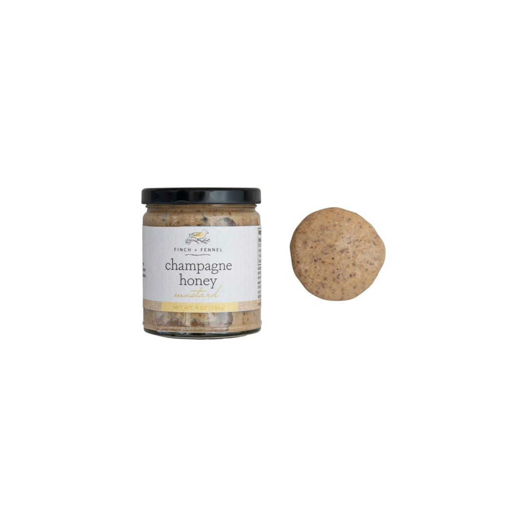 Jar of champagne honey with a cork on a white background