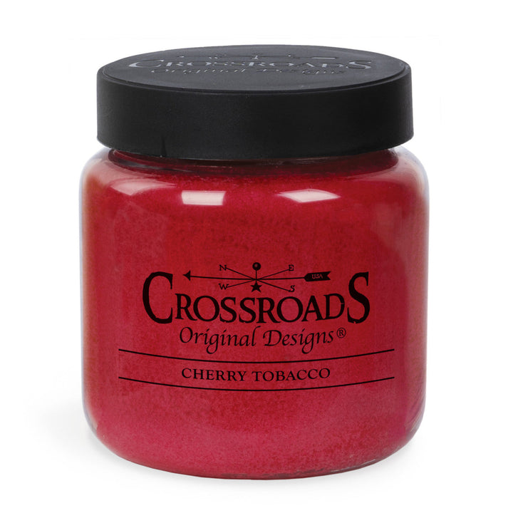 Red candle jar with black lid labeled 'Crossroads Original Designs Cherry Tobacco' on a white background