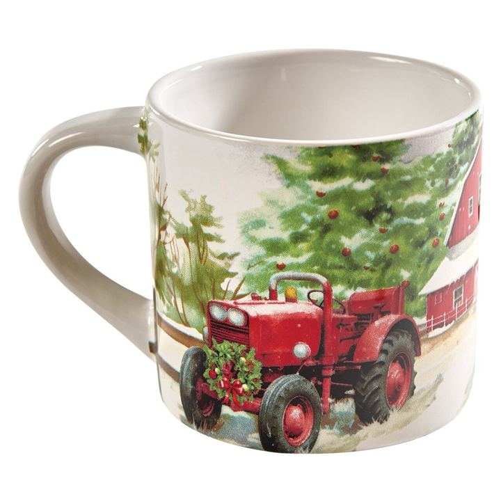 A white ceramic mug featuring a festive winter farm illustration with a red tractor, evergreen trees, a red barn, and snow.
