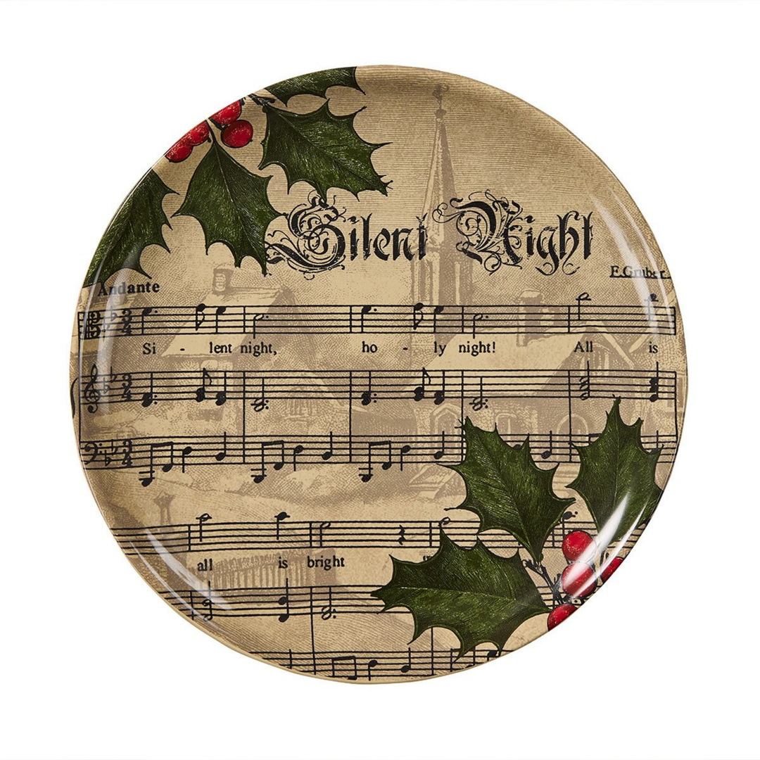 Decorative plate with sheet music, holly leaves, and 'Silent Night' text on a white background