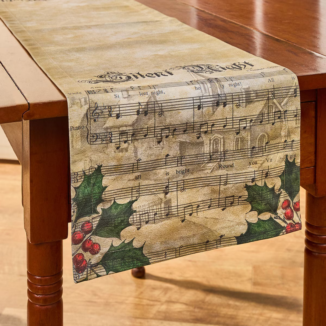 Table runner with musical notes and holly design on a wooden table