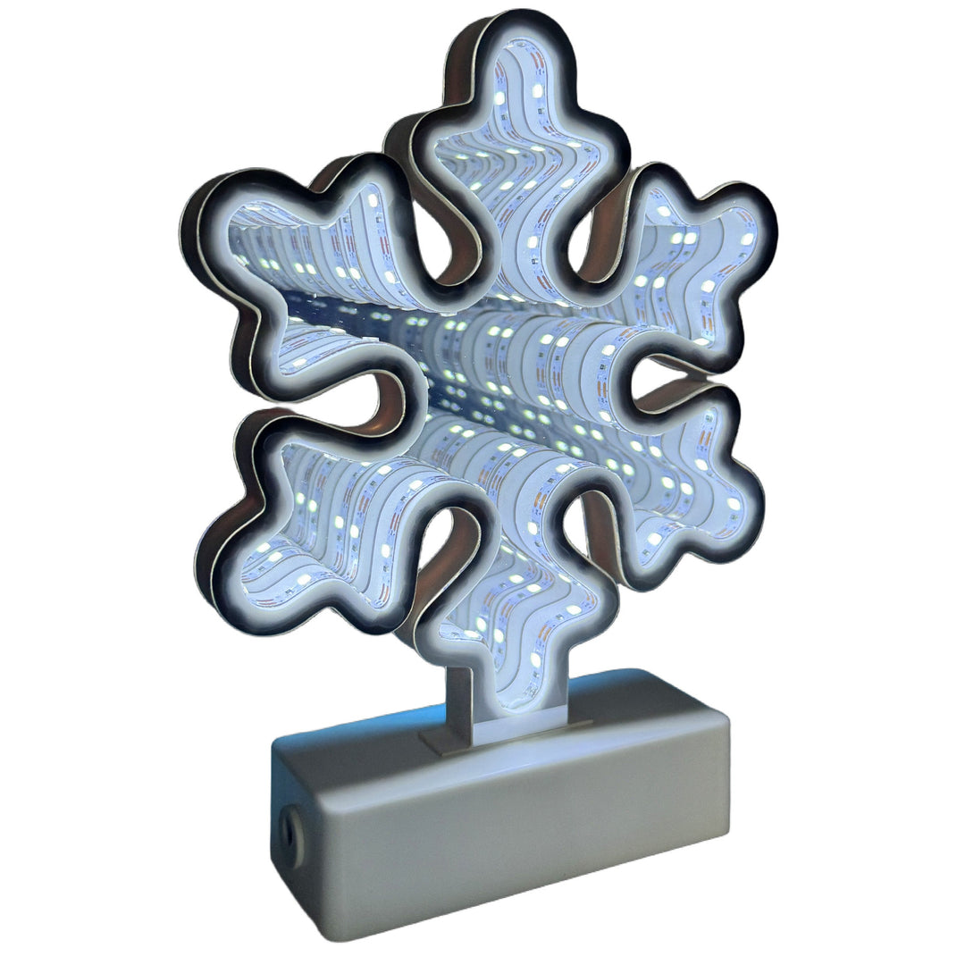 A snowflake-shaped LED light with a gray rectangular base, shown against a plain white background.