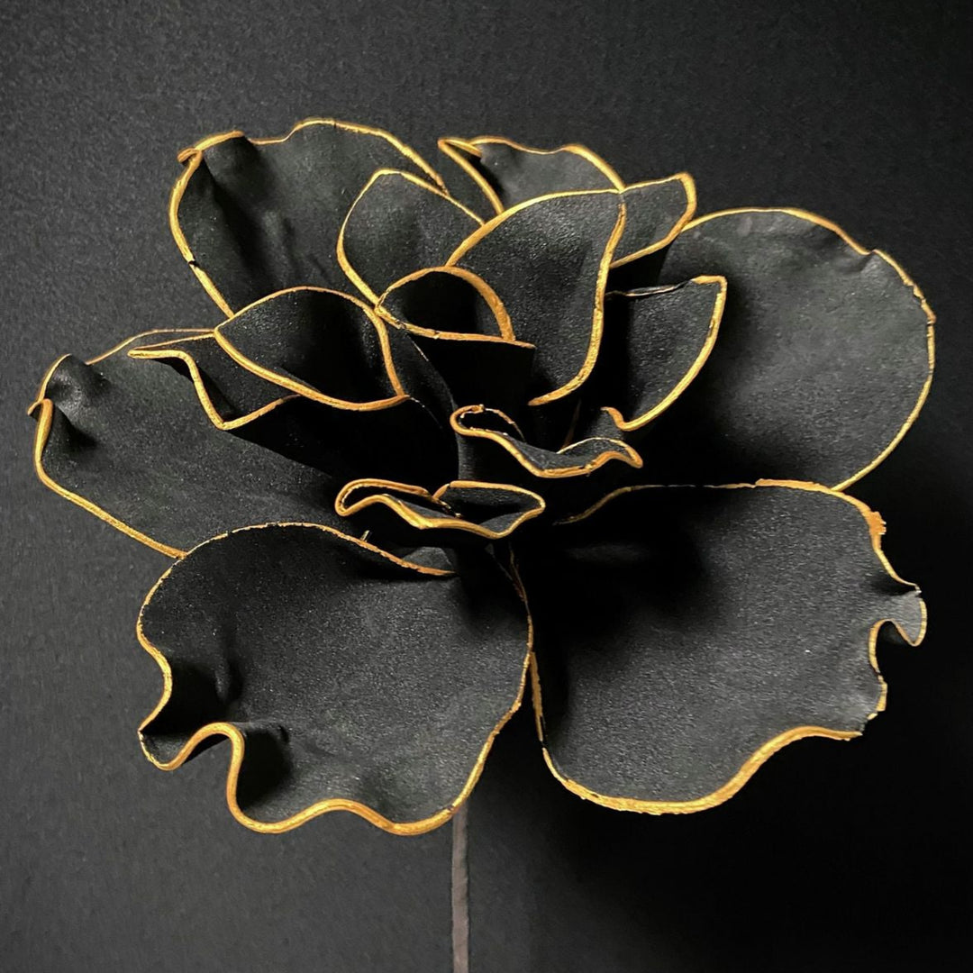 Black flower with gold edges on a black background