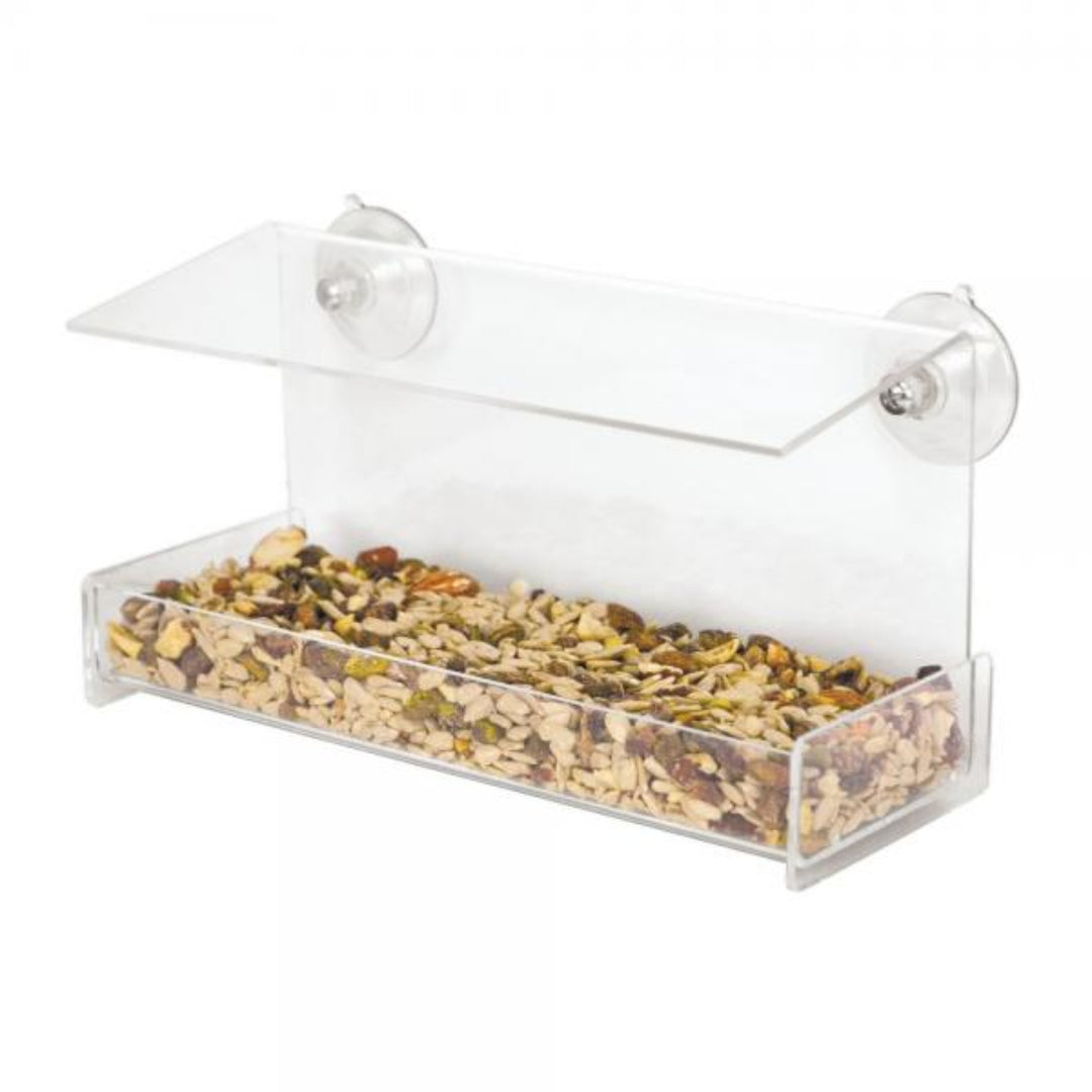 Clear bird feeder with seeds on a white background