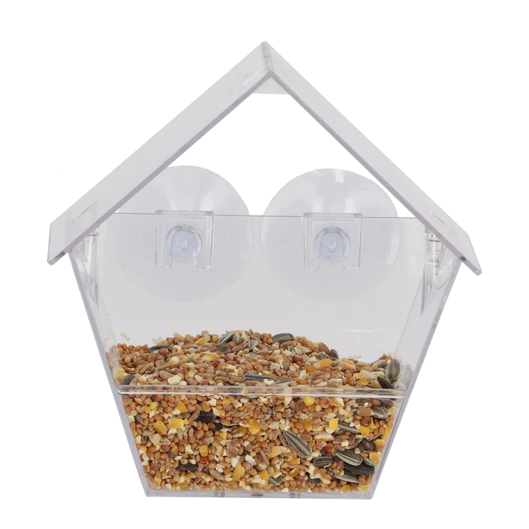 Clear bird feeder with seeds inside on a white background