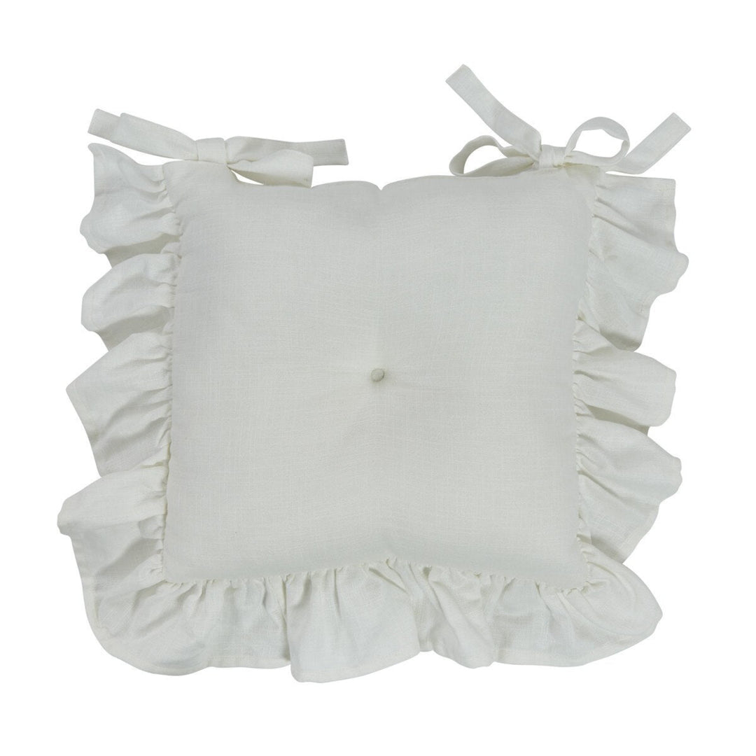 White cushion with ruffled edges and ribbon ties on a white background