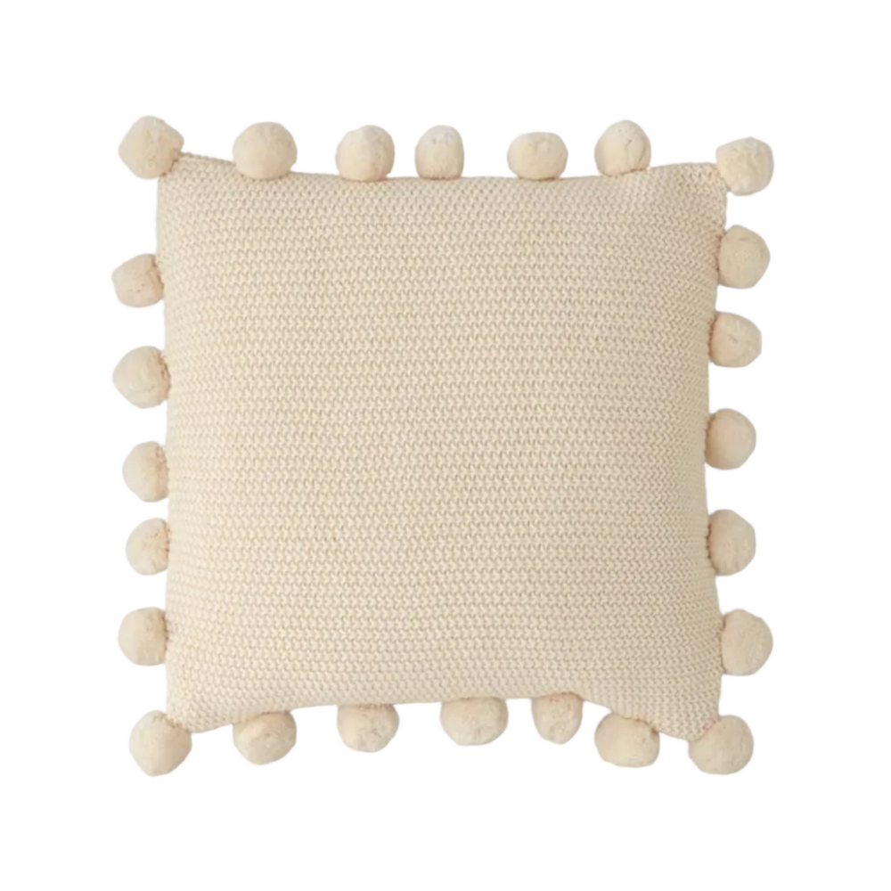 Beige pillow with pom-pom details on a white background