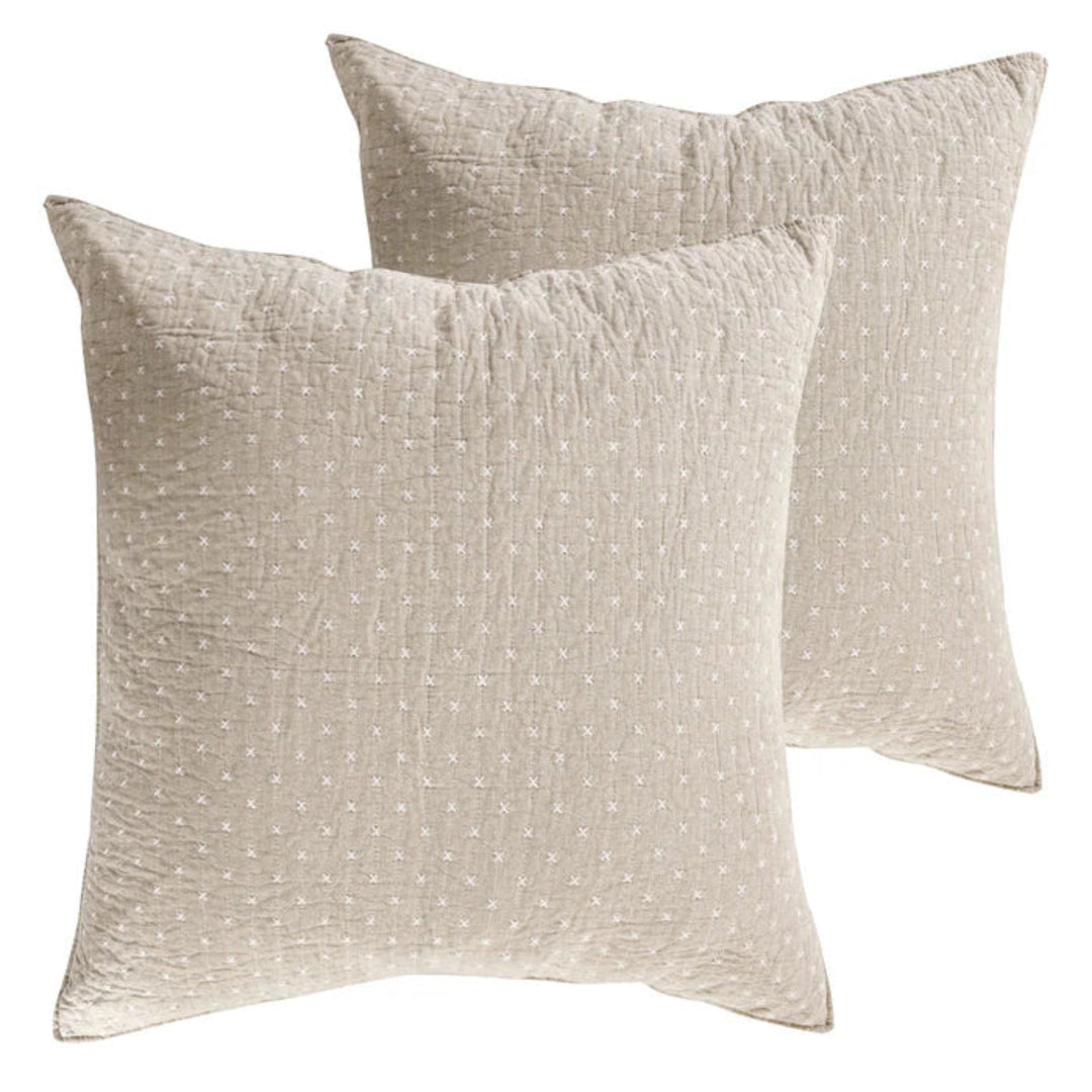 Two beige textured pillows on a white background