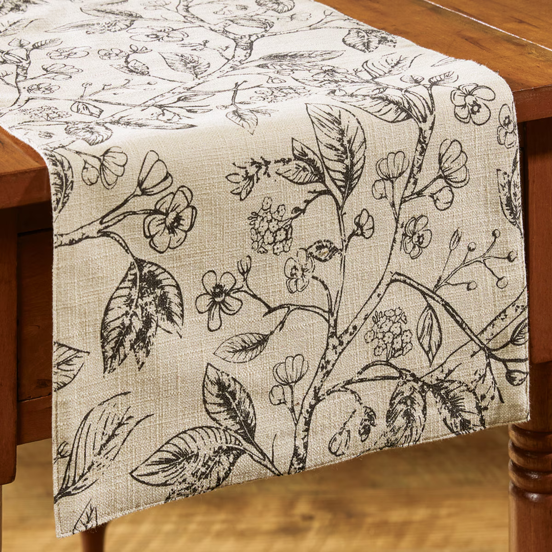 Floral patterned table runner on a wooden table