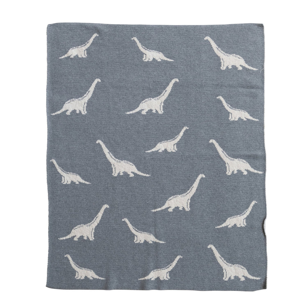 Gray blanket with white dinosaur patterns on a white background