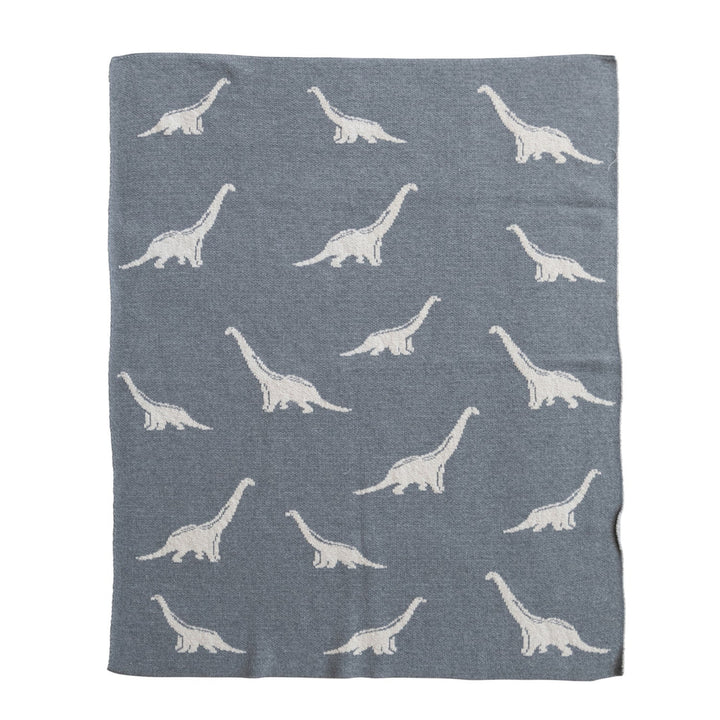Gray blanket with white dinosaur patterns on a white background