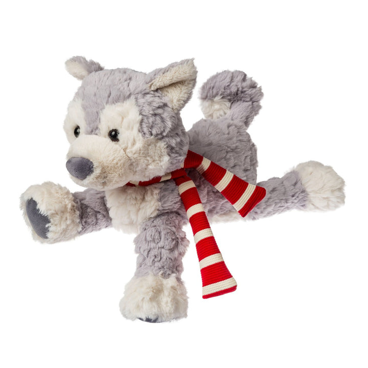 Plush wolf toy with a red and white striped scarf on a white background