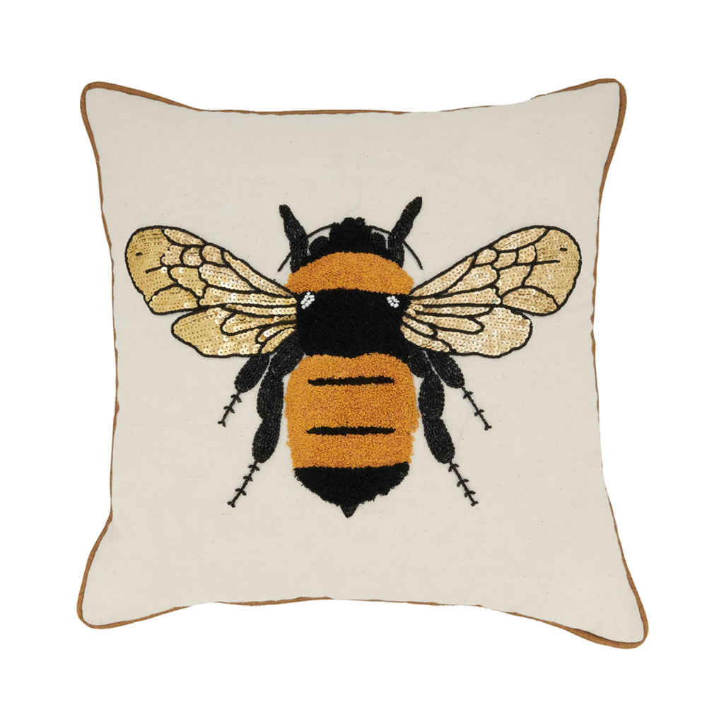 Decorative pillow with a bee design on a white background