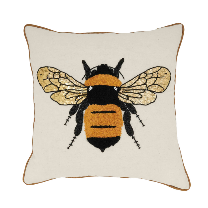 Decorative pillow with a bee design on a white background
