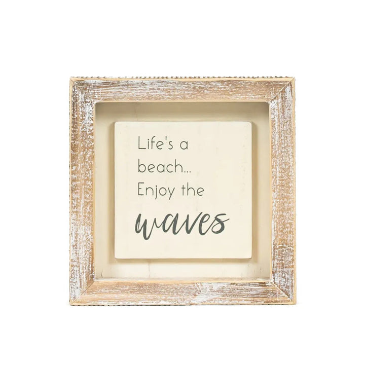 Framed motivational quote 'Life's a beach... Enjoy the waves' on a white background