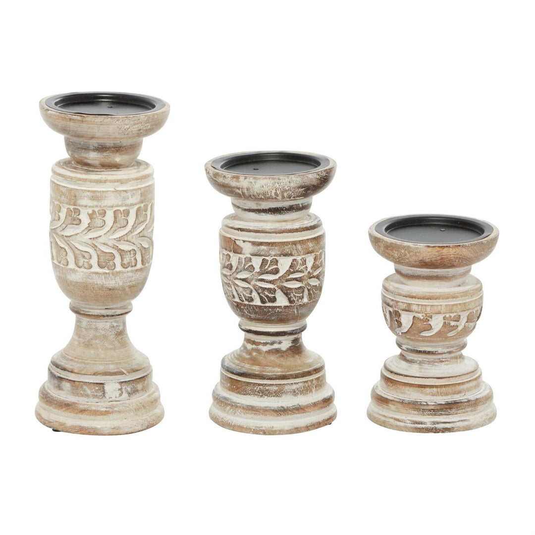 Three distressed wood candle holders in a tiered set, featuring carved leaf patterns and a rustic whitewashed finish with dark interiors, shown on a white background.